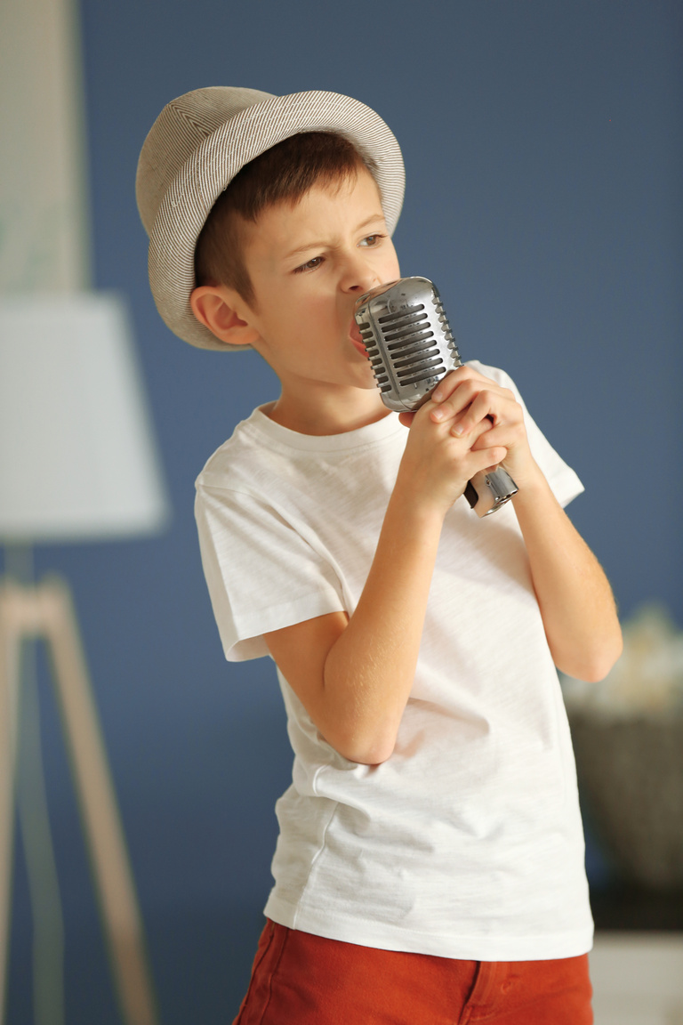 Boy Singing with Microphone at Home